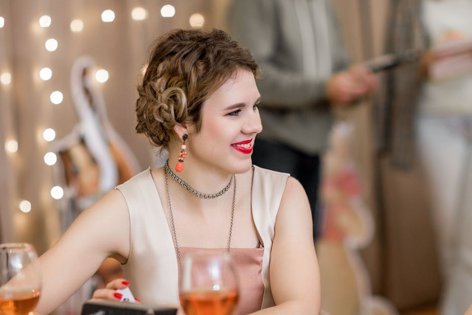 A smiling adult woman enjoys a party with sparkling wine and warm lights indoors.