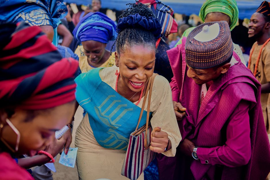 Group of people enjoying a vibrant and colorful cultural celebration outdoors.